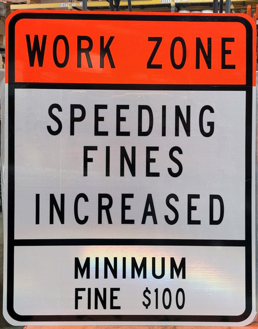 White, black and orange traffic sign that says Work Zone Speeding Fines Increased Minimum Fine $100