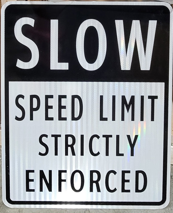 SLOW Speed Limit Strictly Enforced Sign in black and white