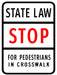 STATE LAW STOP FOR Pedestrians in crosswalk white, black and red sign