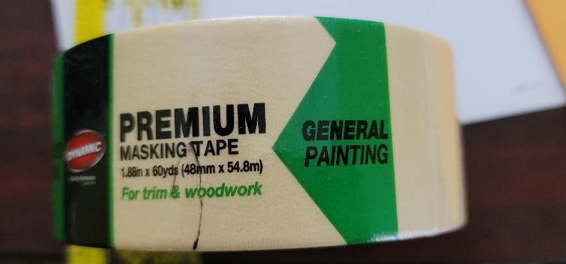 Roll of Dynamic 99828 2" Tan Premium Masking Tape  with Green, black and clear label wrapping