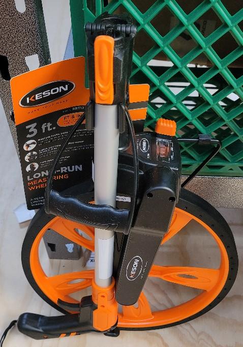 Orange and black Keson Measuring Wheel, Top Reading with Thumb Reset, Molded Spoke, Units: FT and IN