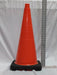 28: orange traffic cone with black base upright against a white background